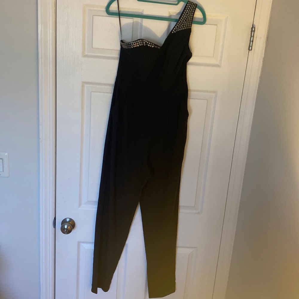 GUESS One-shoulder metal studs pleated jumpsuit in black. Size 4.